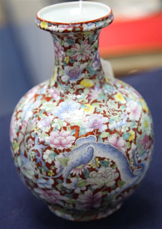 A Chinese coral ground dragon bottle vase, Qianlong seal mark, early 20th century, 19cm